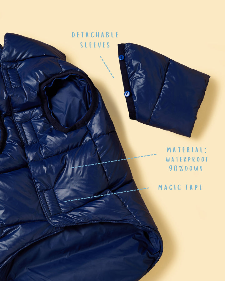Blue puffer jacket with detachable sleeves on a beige background
