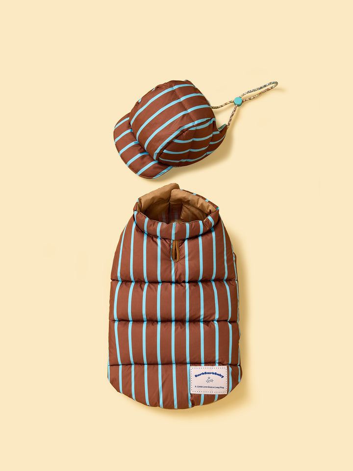 Brown and blue striped pet puffer coat with matching hat on a beige background