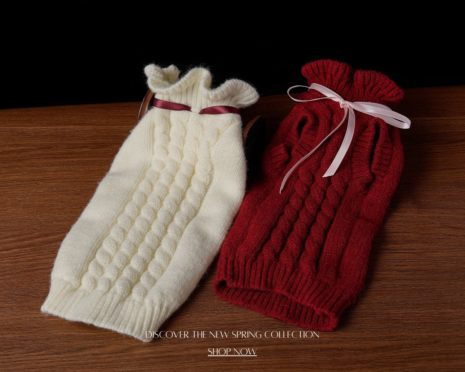 White and red knitted dog sweaters on a wooden surface with text overlay.